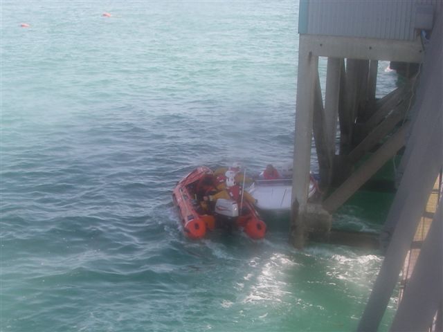 Speedboat Pinned by Boathouse