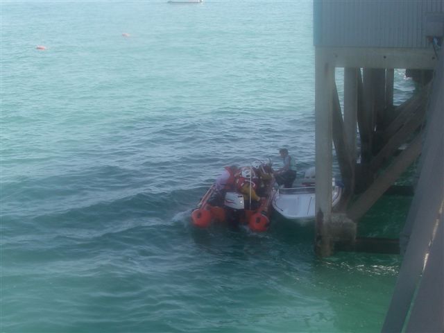 Speedboat Pinned by Boathouse