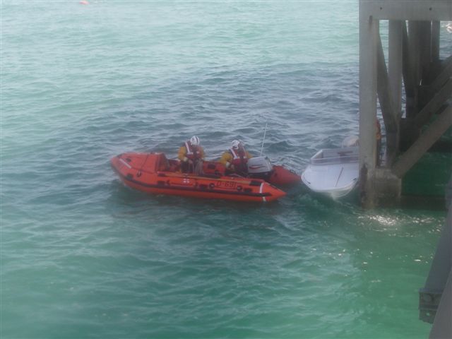 Speedboat Pinned by Boathouse