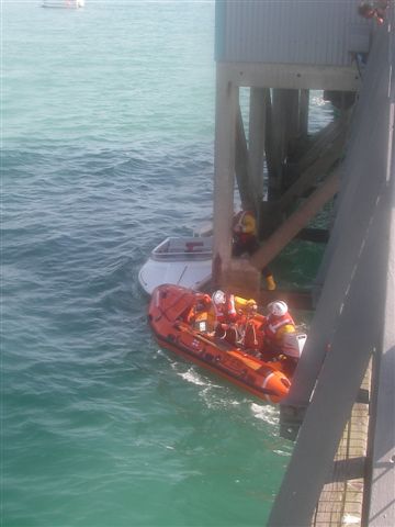 Speedboat Pinned by Boathouse