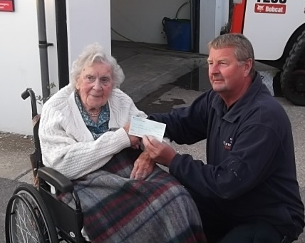 Muriel presenting the cheque to Coxswain, Martin Rudwick